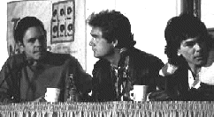 [Black And White Photo. L To R Bob Weir, Huey Lewis And Mickey Hart Seated Behind A Table At A Press Conference]